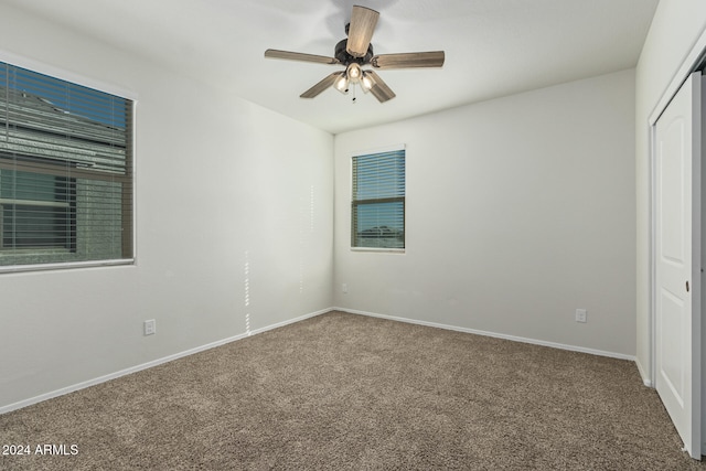 unfurnished bedroom with carpet floors, ceiling fan, and a closet