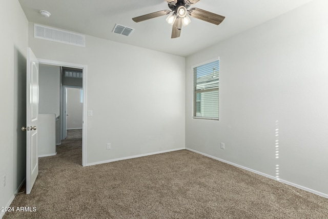 empty room with ceiling fan and carpet floors