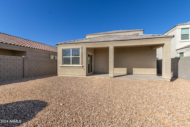 back of property with a patio