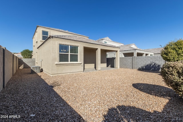 rear view of house featuring central air condition unit and a patio area