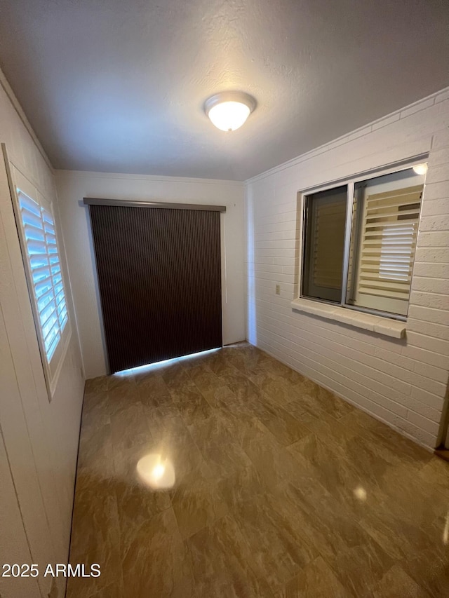 440 S Parkcrest Unit 22, Mesa, AZ 85206 - unfurnished room featuring ornamental molding and wooden walls