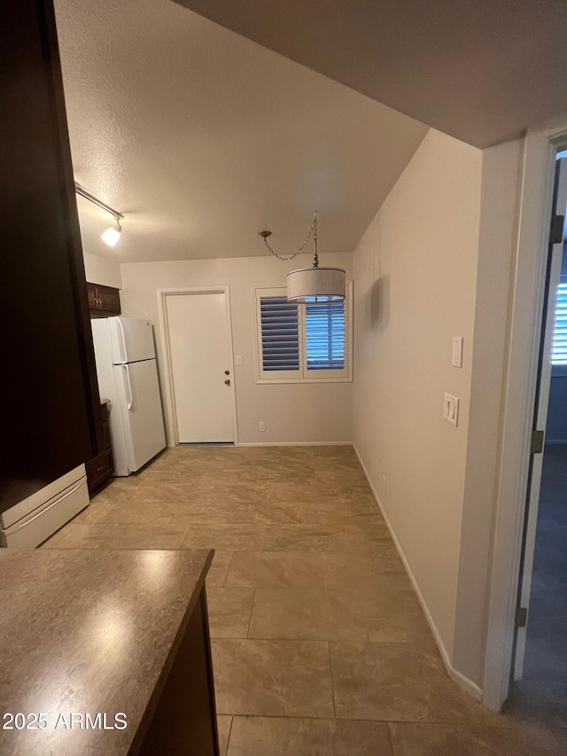 440 S Parkcrest Unit 22, Mesa, AZ 85206 - unfurnished dining area featuring a baseboard heating unit, track lighting, and a textured ceiling
