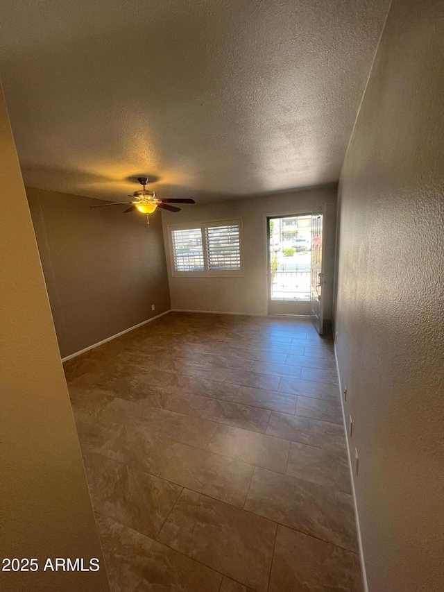 440 S Parkcrest Unit 22, Mesa, AZ 85206 - spare room featuring a textured ceiling and a ceiling fan