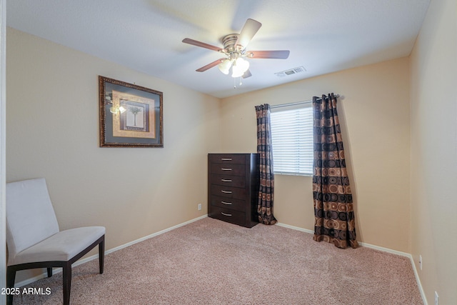 sitting room with light carpet, ceiling fan, visible vents, and baseboards