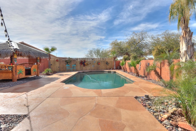 view of swimming pool with a fenced in pool and a fenced backyard