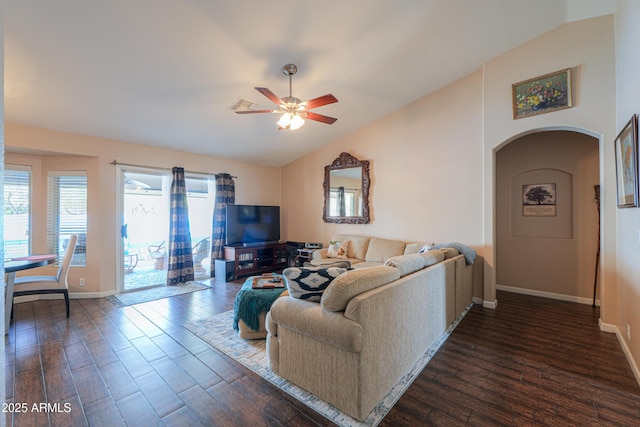 living room featuring a ceiling fan, lofted ceiling, dark wood finished floors, and arched walkways