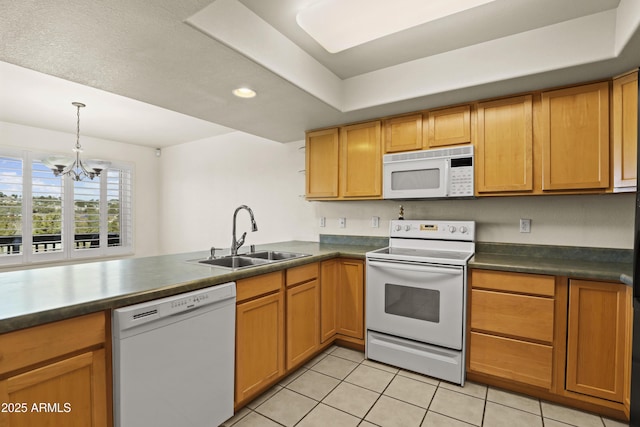 kitchen featuring sink, white appliances, light tile patterned floors, an inviting chandelier, and kitchen peninsula