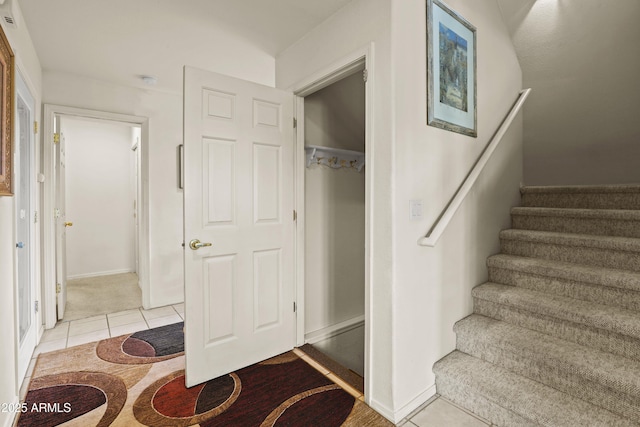 stairway with tile patterned flooring