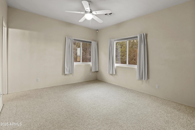 spare room with ceiling fan and carpet floors