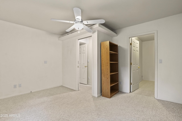 unfurnished bedroom with ceiling fan and light carpet