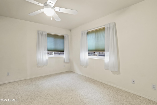 empty room featuring ceiling fan and carpet flooring