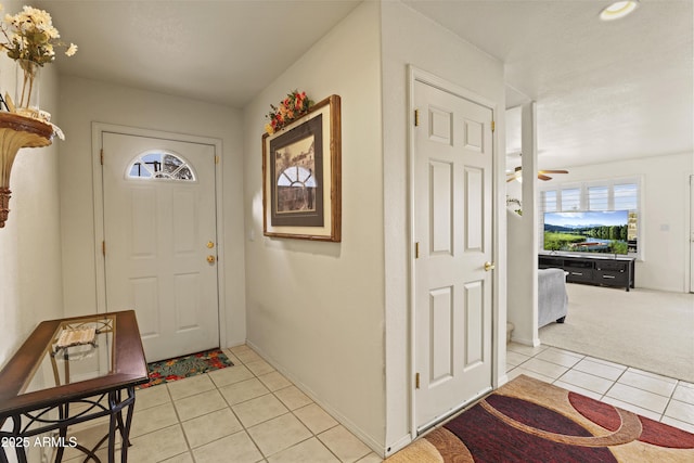 tiled foyer with ceiling fan