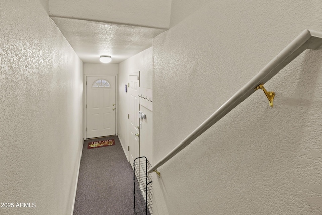 interior space with a textured ceiling and carpet