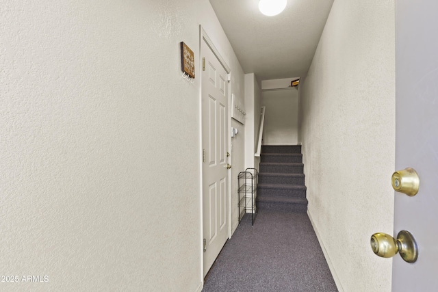 hall featuring dark colored carpet