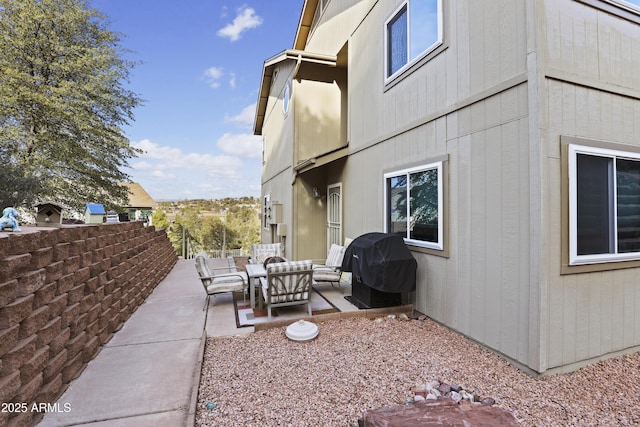 view of side of home with an outdoor living space and a patio