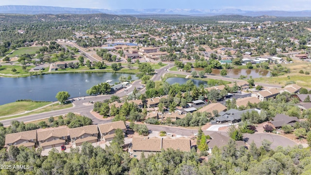 drone / aerial view with a water and mountain view