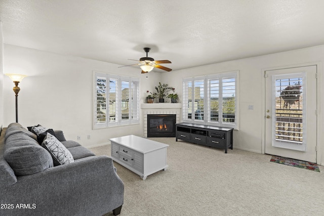 carpeted living room with ceiling fan and a textured ceiling