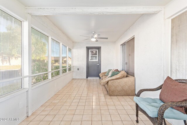sunroom with tile patterned floors and ceiling fan
