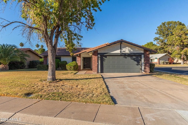 view of front facade with brick siding, an attached garage, concrete driveway, and a front lawn