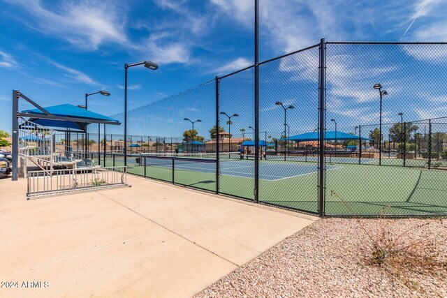 view of tennis court with fence