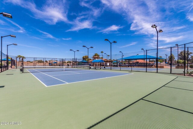 view of sport court featuring fence
