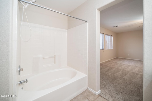 bathroom with washtub / shower combination and tile patterned floors