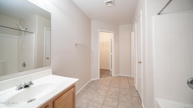 bathroom featuring a shower, vanity, and tile patterned flooring