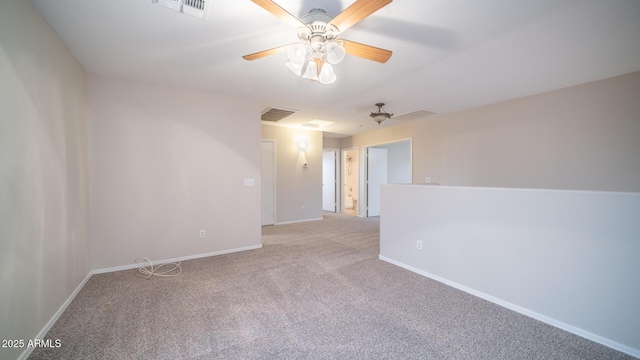 spare room with ceiling fan and light colored carpet