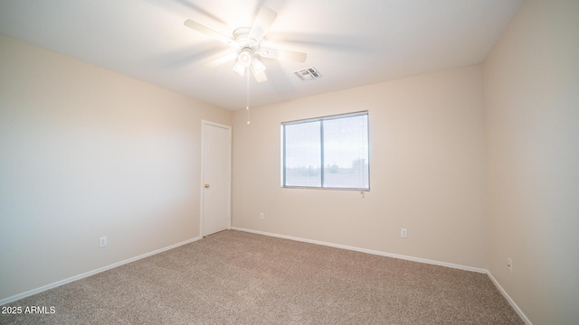 unfurnished room featuring ceiling fan and carpet floors