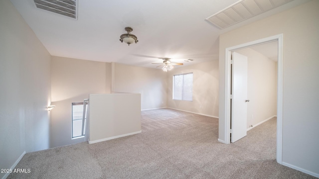 spare room with light carpet and ceiling fan