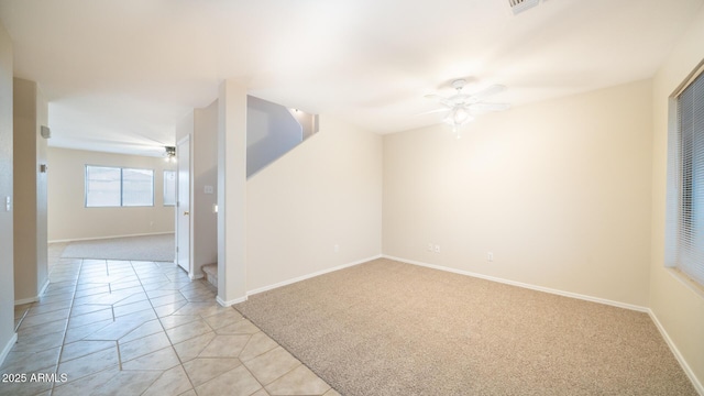 tiled empty room featuring ceiling fan