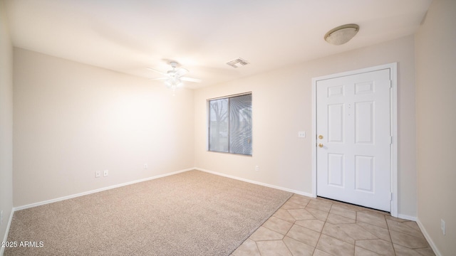 spare room with light tile patterned floors and ceiling fan