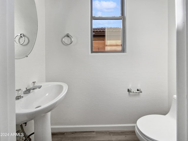 bathroom with sink, hardwood / wood-style floors, and toilet