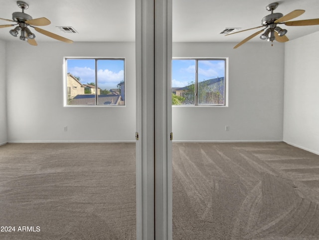 carpeted empty room featuring ceiling fan