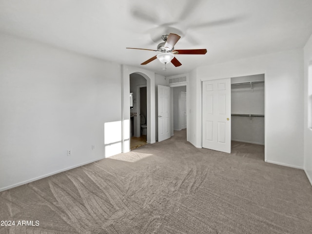 unfurnished bedroom with a closet, ceiling fan, and carpet floors