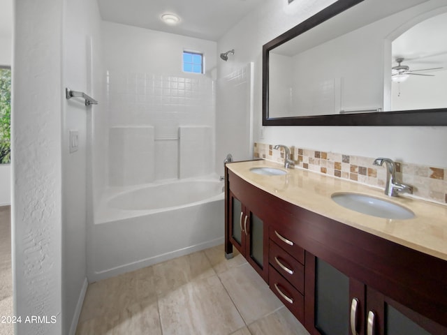 bathroom featuring decorative backsplash, ceiling fan, shower / tub combination, and vanity