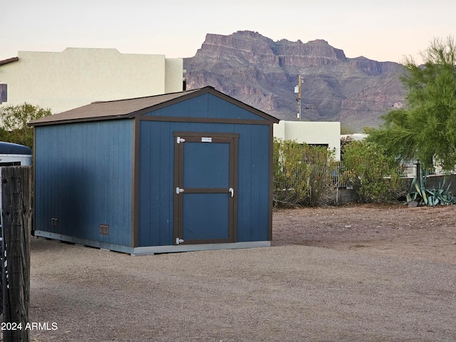 outdoor structure at dusk featuring a mountain view