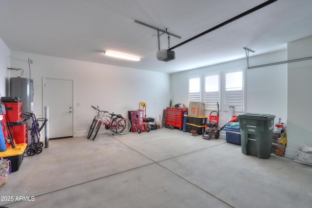 garage featuring a garage door opener and water heater