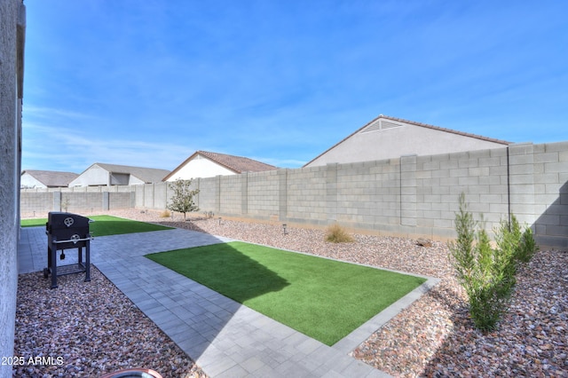 view of yard with a patio and a fenced backyard