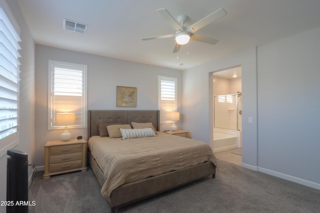 bedroom with ceiling fan, ensuite bath, and carpet floors