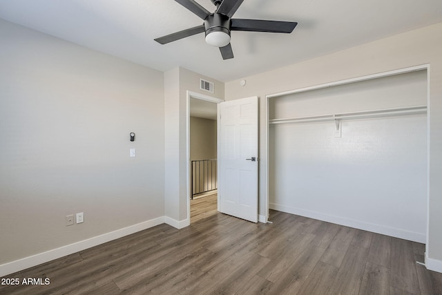 unfurnished bedroom featuring wood-type flooring, a closet, and ceiling fan