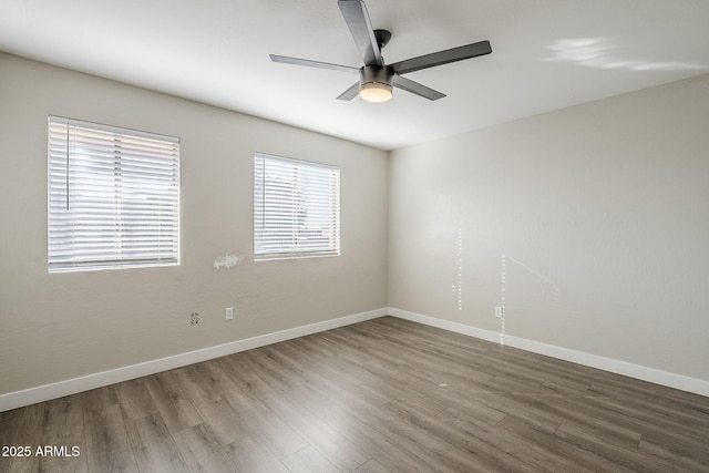 spare room with hardwood / wood-style floors and ceiling fan