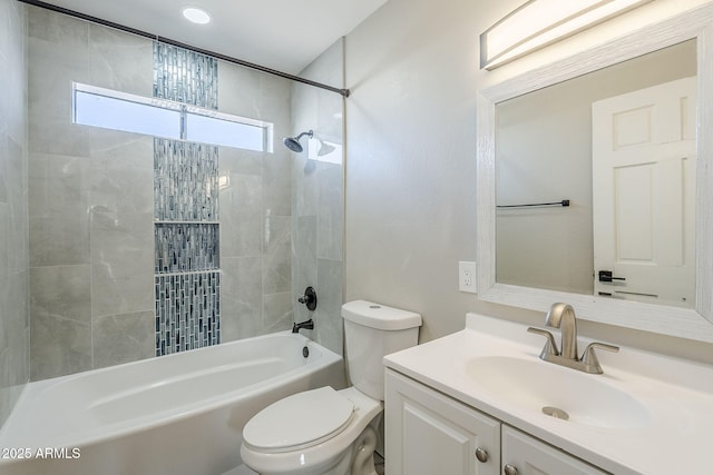 full bathroom with toilet, tiled shower / bath, and vanity