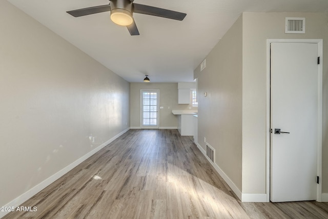 unfurnished living room featuring ceiling fan and light wood-type flooring