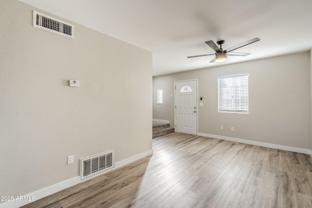 foyer with ceiling fan and light wood-type flooring