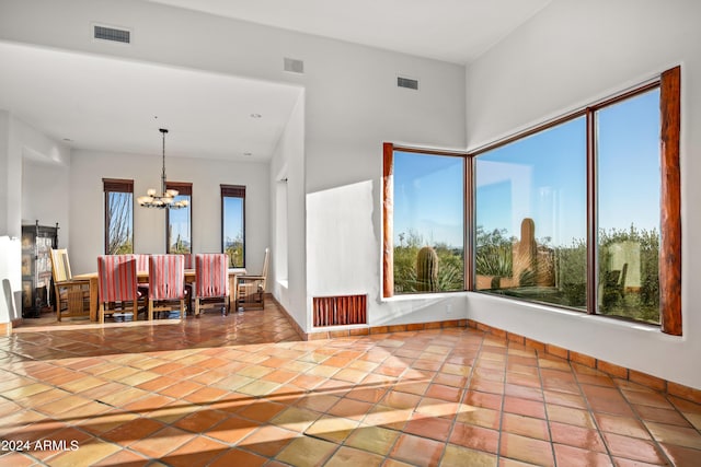 interior space with light tile floors and a notable chandelier