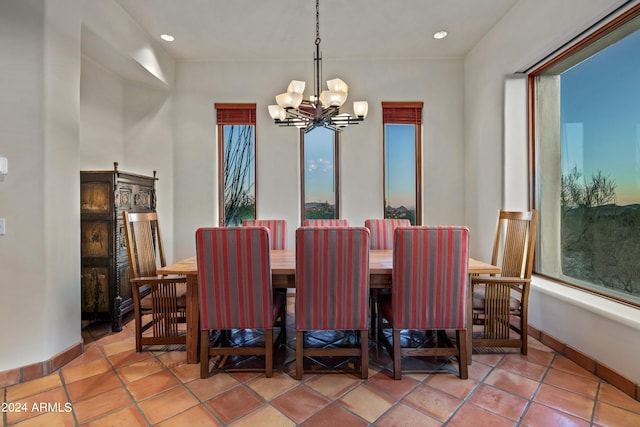 dining space featuring an inviting chandelier and light tile flooring