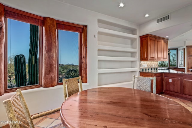 dining space featuring light tile floors