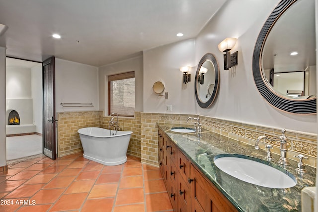 bathroom featuring large vanity, double sink, a bathing tub, tasteful backsplash, and tile floors