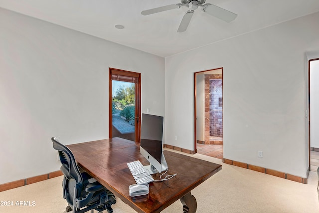 office space with light colored carpet and ceiling fan